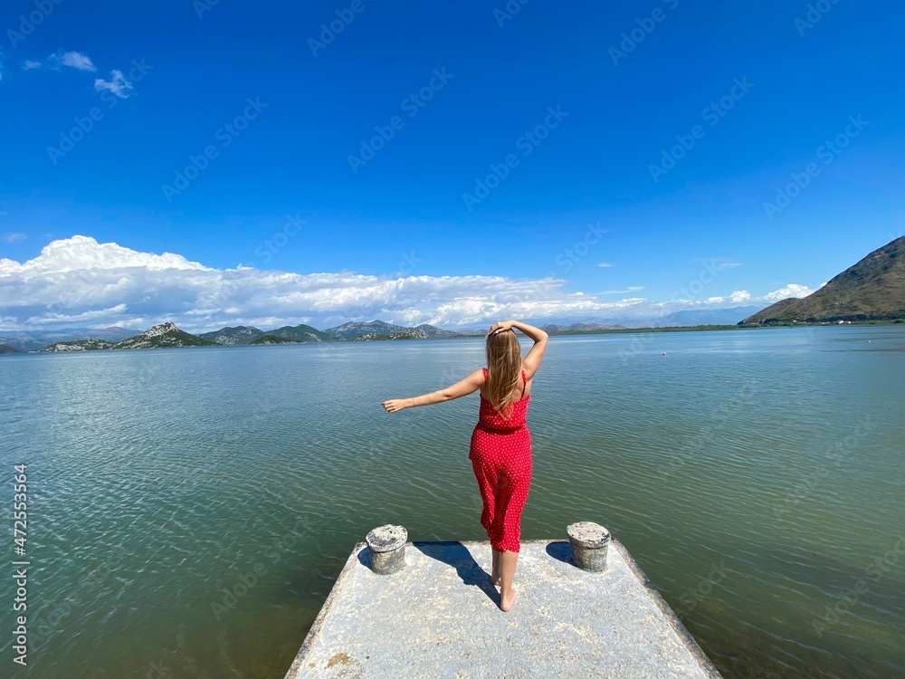 Young girl in a trendy red clothes enjoying the beauty of nature, relaxing, adventure, amazing nature, tour agency concept.