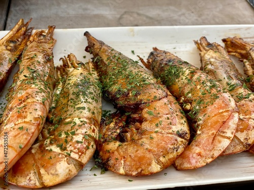 Delicious fried shrims, Grilled giant river prawn on a white plate, Barbecue seafood party, Traditional food recipe.