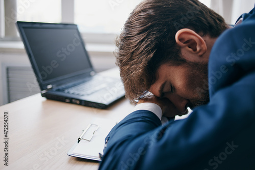 businessmen sitting at a desk in front of a laptop finance network official