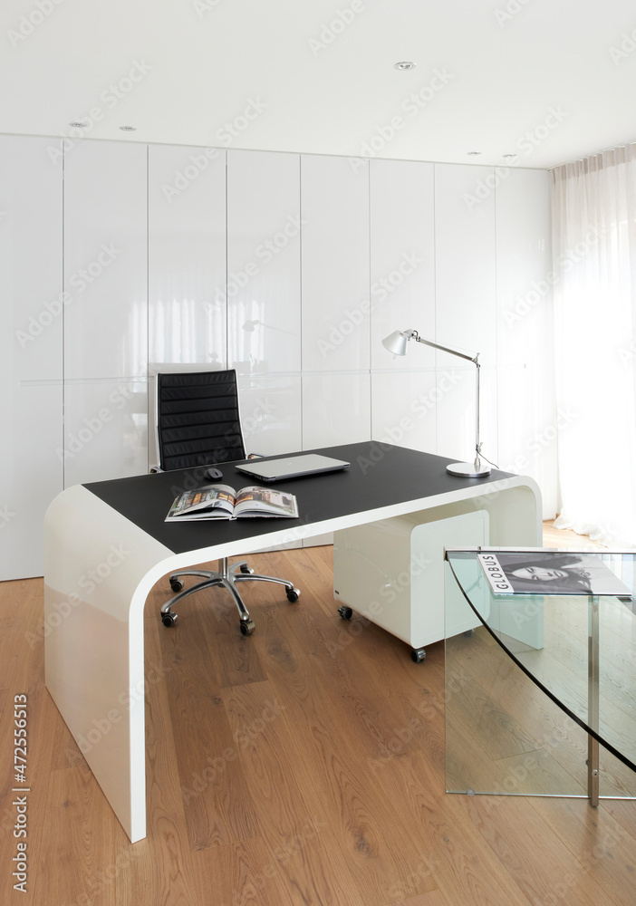 Luminous office room with a black and white desk Stock Photo | Adobe Stock