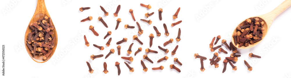 Set of spice clove (Syzygium aromaticum) in wooden spoon, scattering on white background isolated. Close up, macro. Flat lay Set of spice clove (Syzygium aromaticum) in wooden spoon, scattering on white background isolated. Close up, macro. Flat lay