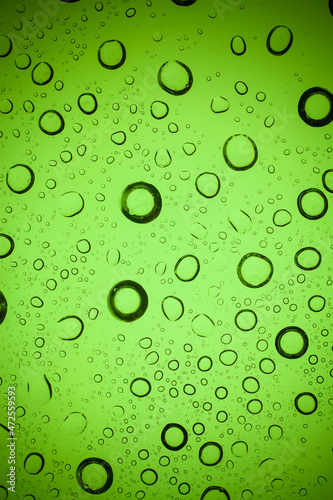Texture water drops on green glass.