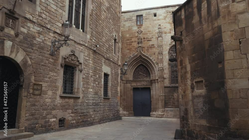Barcelona - Carrer de la Pietat with ancient doorways, barred windows and the stone walls of the Cathedral of Barcelona Barcelona - Carrer de la Pietat with ancient doorways, barred windows and the stone walls of the Cathedral of Barcelona