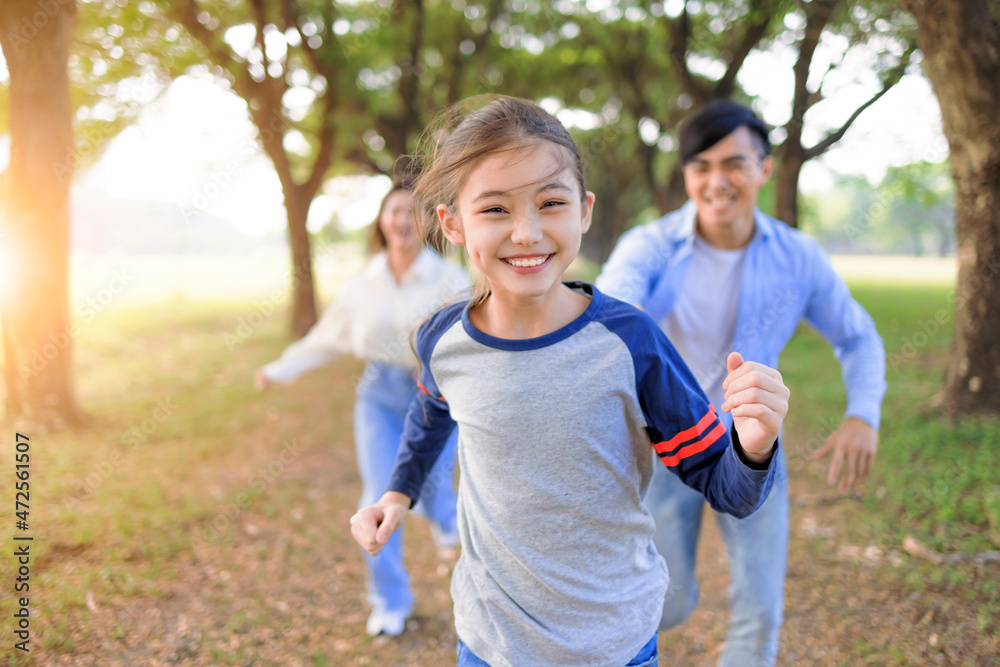 Happy Family running and playing together in the park Happy Family running and playing together in the park