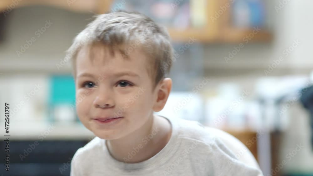 Sick child shows tongue and grimaces indulging in the kitchen