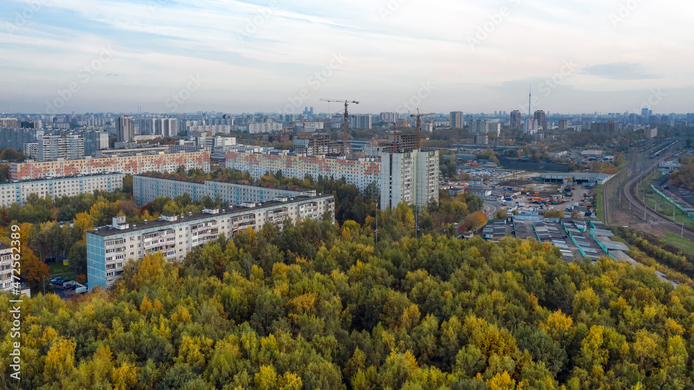 Aerial view of residential buildings in the Moscow district of Lianozovo and Beskudnikovo from the side of Linozovsky Park on a summer evening at sunset. 