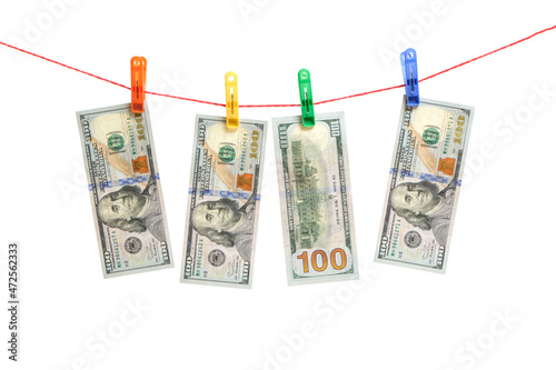 Hundred dollar bills are suspended on clothespins on white background.Money laundering.