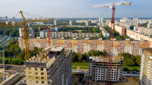 New high-rise apartment buildings under construction. Aerial photo at sunny evening