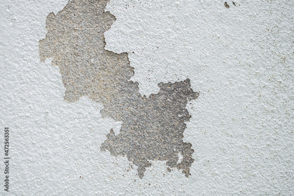 Abstract old white concrete wall with peeling paint