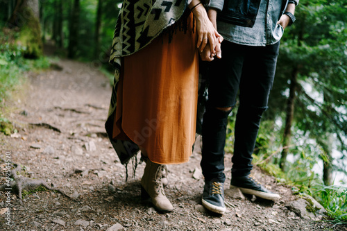 Man and woman are standing on a trail in the forest. Close-up