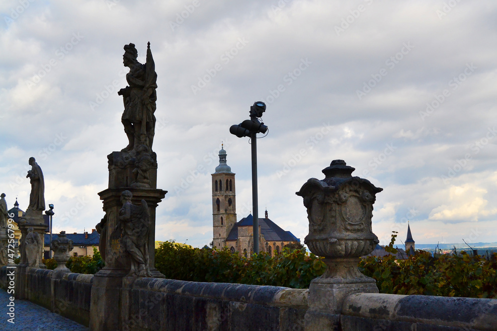 Beautiful statues near Cathedral of St. Barbara and Church of St. James on the background. Kutna Hora, Central Bohemian Region, Czech Republic. 