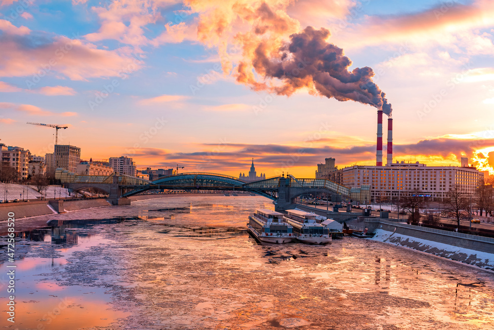 Winter Moscow river scenery. Beautiful Sunset under icebreak Moscow river on dramatic sky. Russia, Moscow, february 2020