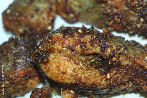 Spicy and crunchy barbecue of fried fish fillet on a white background