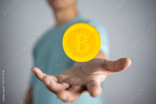 Glowing Bitcoin coin in hand illustration.