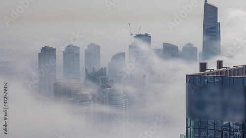 Photography Fog covered skyscrapers in JLT district aerial timelapse.