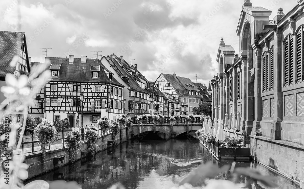 Beautiful view of Colmar city with flowers in water canal and traditional half timbered houses in Alsace , France.Tourist attraction in France.Black and white photography