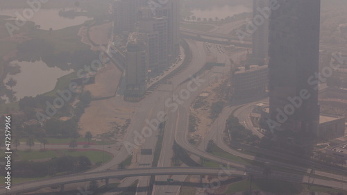 Big crossroad junction between JLT district and Dubai Marina intersected by Sheikh Zayed Road all day aerial timelapse.