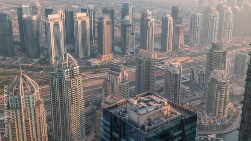 JLT skyscrapers near Sheikh Zayed Road aerial timelapse. Residential buildings and villas behind