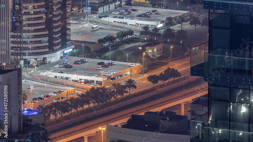 Car parking for light vehicles night timelapse in Dubai luxury residential district, aerial view from above.