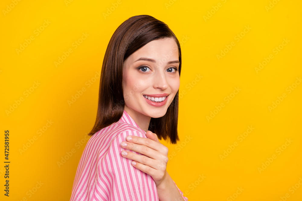 Profile photo of adorable gorgeous person hand on shoulder look camera isolated on yellow color background Profile photo of adorable gorgeous person hand on shoulder look camera isolated on yellow color background