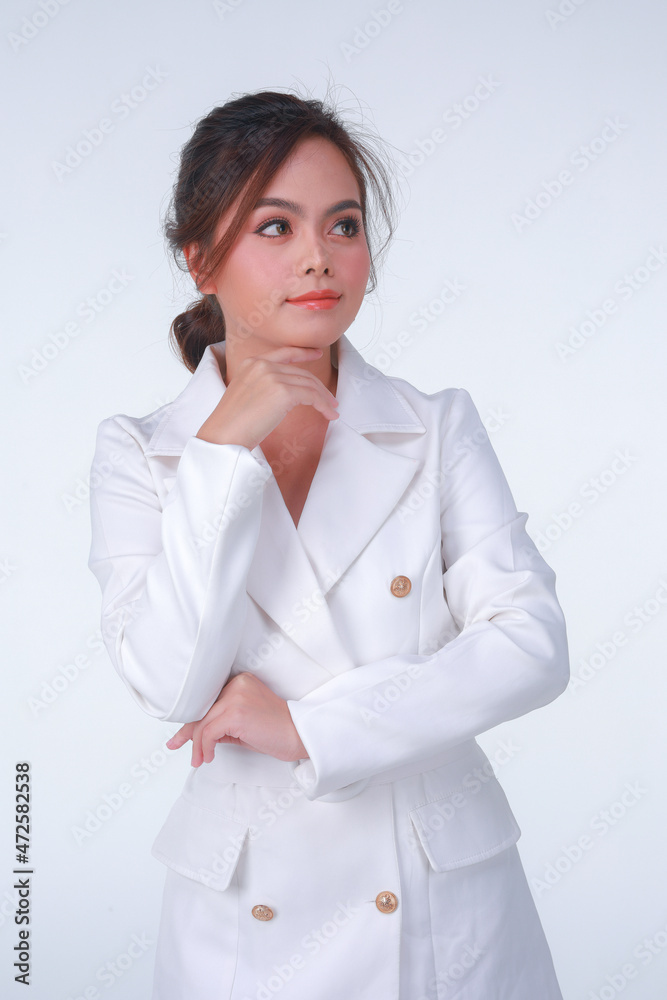 Young business charming confident woman in white suit at the studio white background. Young business charming confident woman in white suit at the studio white background.