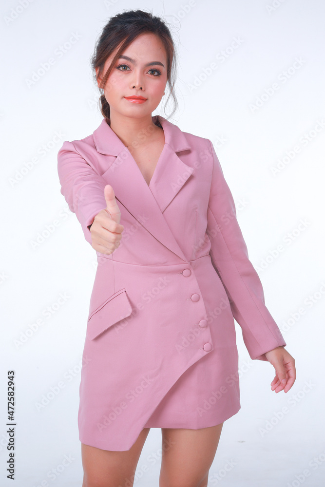 Young business charming confident woman in pink suit at the studio white background. Young business charming confident woman in pink suit at the studio white background.