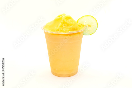 Peach slush with lemon slice served in a disposable cup. photo