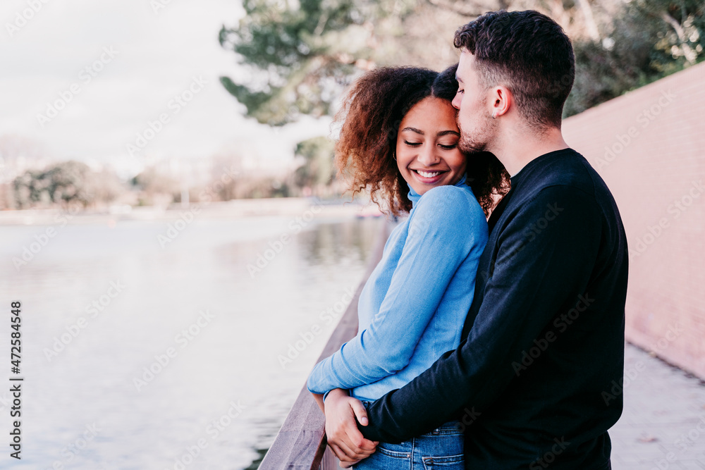 Young boyfriend kissing girlfriend by railing Young boyfriend kissing girlfriend by railing