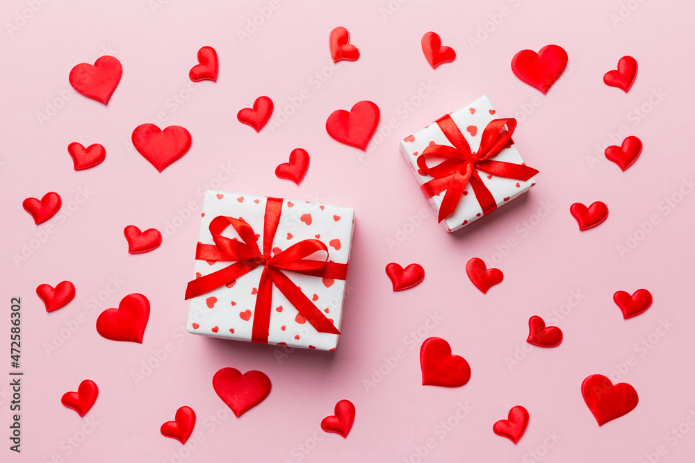 Valentine day composition Background: red gift box with bow and heart. Christmas present. View from above. Holday greeting card Valentine day composition Background: red gift box with bow and heart. Christmas present. View from above. Holday greeting card