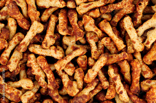 Crunchy knobbly twig shaped wheat savoury party snacks with a yeast flavour coating background