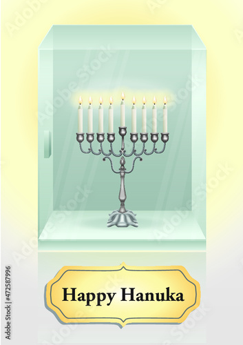 A glass display case with a menorah with wax candles lit in honor of Hanukkah