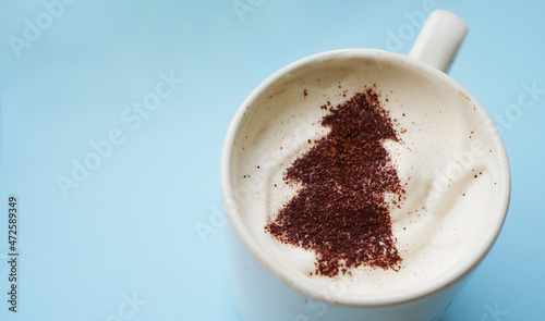 Christmas tree made of cocoa powder on frothy coffee. Winter holidays hot drinks. Milk foam art. 