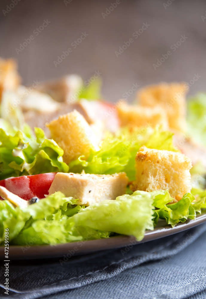 Green vegetable salad with lattuce, chicken and croutons. Healthy food concept