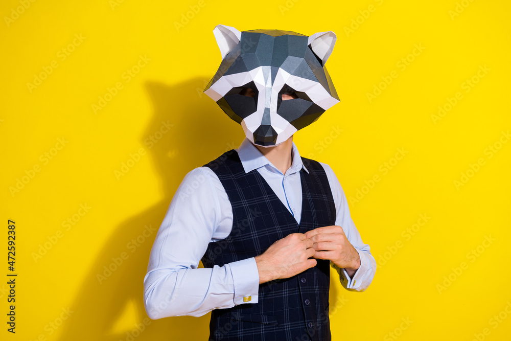 Photo of confident guy fix stylish outfit prepare theme party wear raccoon mask vest isolated yellow color background Photo of confident guy fix stylish outfit prepare theme party wear raccoon mask vest isolated yellow color background