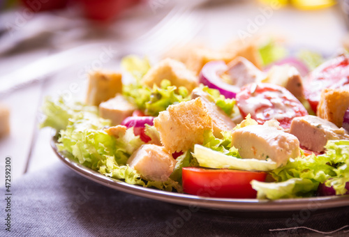 Caesar salad with vegetables, chicken and croutons