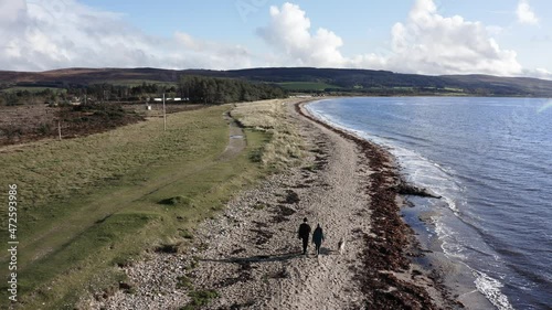 Drone shot flying over a beach on the Kintyre peninsula in Scotland on a sunny day photo