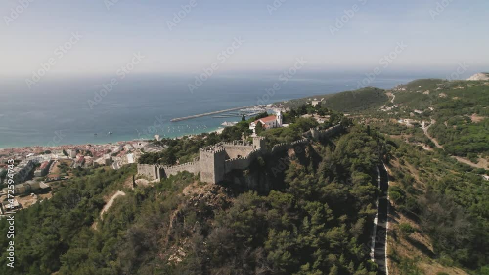 Aerial circle view over city castle and seaside. Sesimbra, Portugal. Real time Aerial circle view over city castle and seaside. Sesimbra, Portugal. Real time