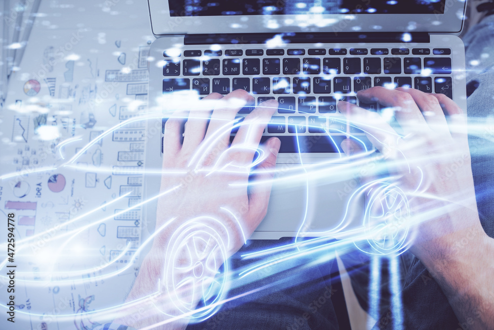 Double exposure of man's hands typing over computer keyboard and automobile theme hologram drawing. Top view. Technology concept. Double exposure of man's hands typing over computer keyboard and automobile theme hologram drawing. Top view. Technology concept.
