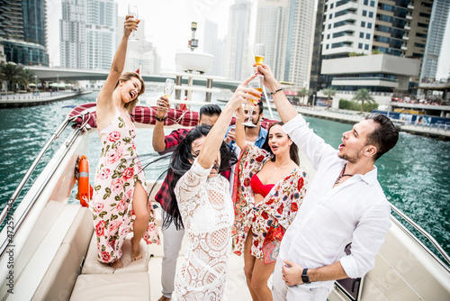 Photography Group of friends making party on a yacht in Dubai