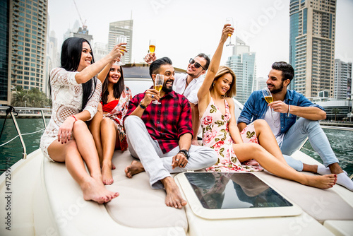 Photography Group of friends making party on a yacht in Dubai