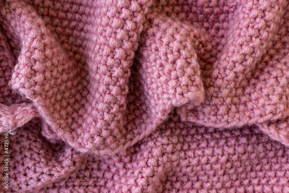 Pink knitted crumpled plaid