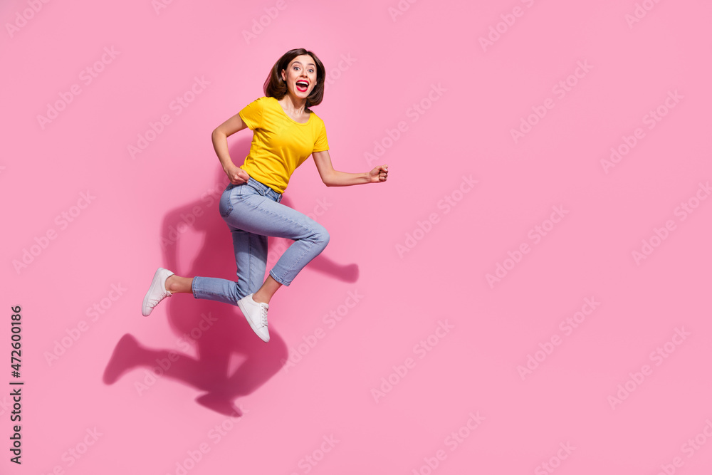 Full length body size view of attractive cheerful girl having fun jumping running isolated over pink pastel color background