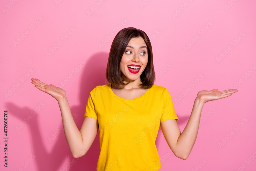 Portrait of attractive cheerful girl holding on palms copy space ad decision isolated over pink pastel color background Portrait of attractive cheerful girl holding on palms copy space ad decision isolated over pink pastel color background
