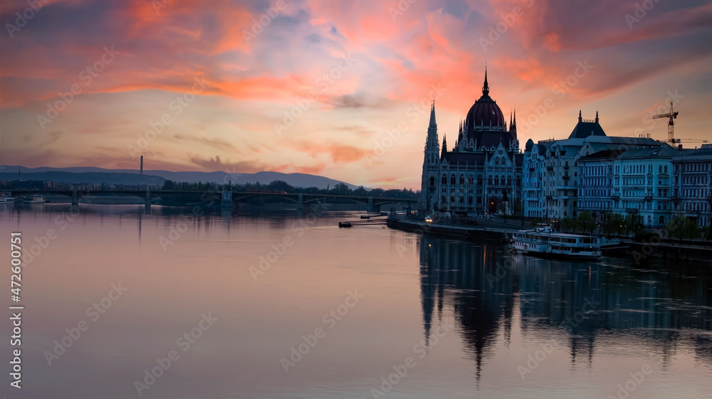 Fototapeta premium Panorama view in sunset scene with building of Hungarian parliament at Danube river in Budapest city, Hungary.