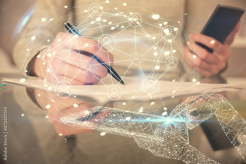 Double exposure of social network sketch hologram and woman holding and using a mobile device. Double exposure of social network sketch hologram and woman holding and using a mobile device.