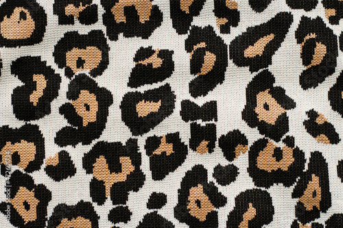 Animal print, leopard pattern fabric background in brown colors. High quality photo