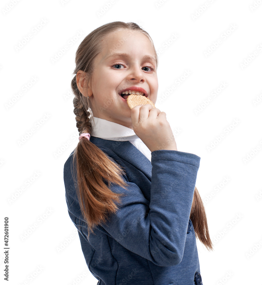 Smiling happy girl eating tasty cookies in studio