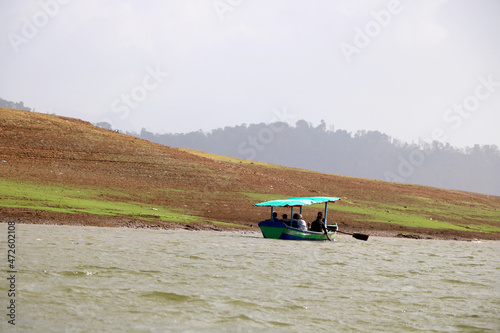 landscape view of ferry boat with tourist for ride in lake of dudhni (India) photo