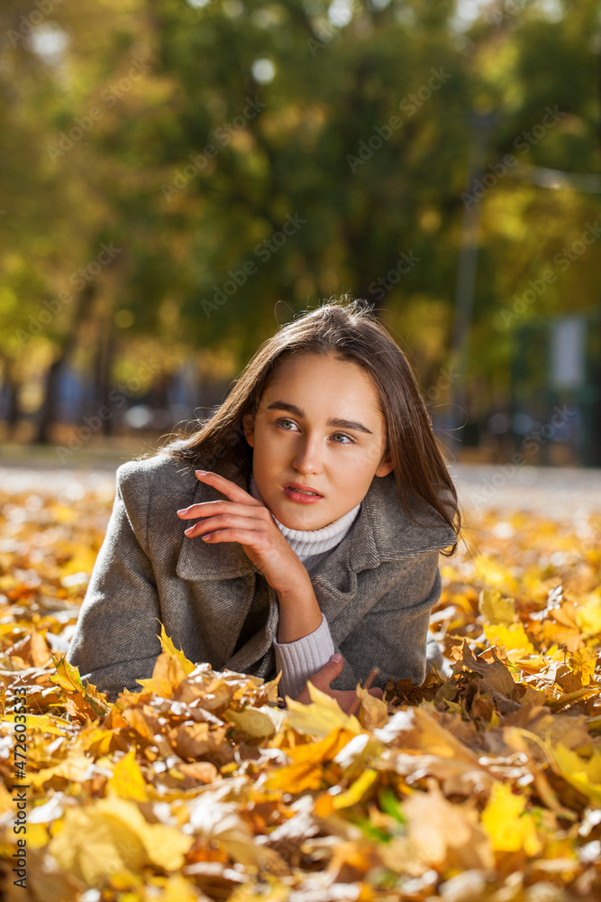 Portrait of a young beautiful brunette woman in autumn park Portrait of a young beautiful brunette woman in autumn park