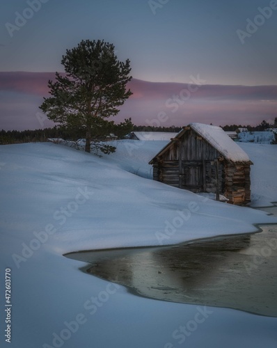 Winter old beautiful village by the river photo